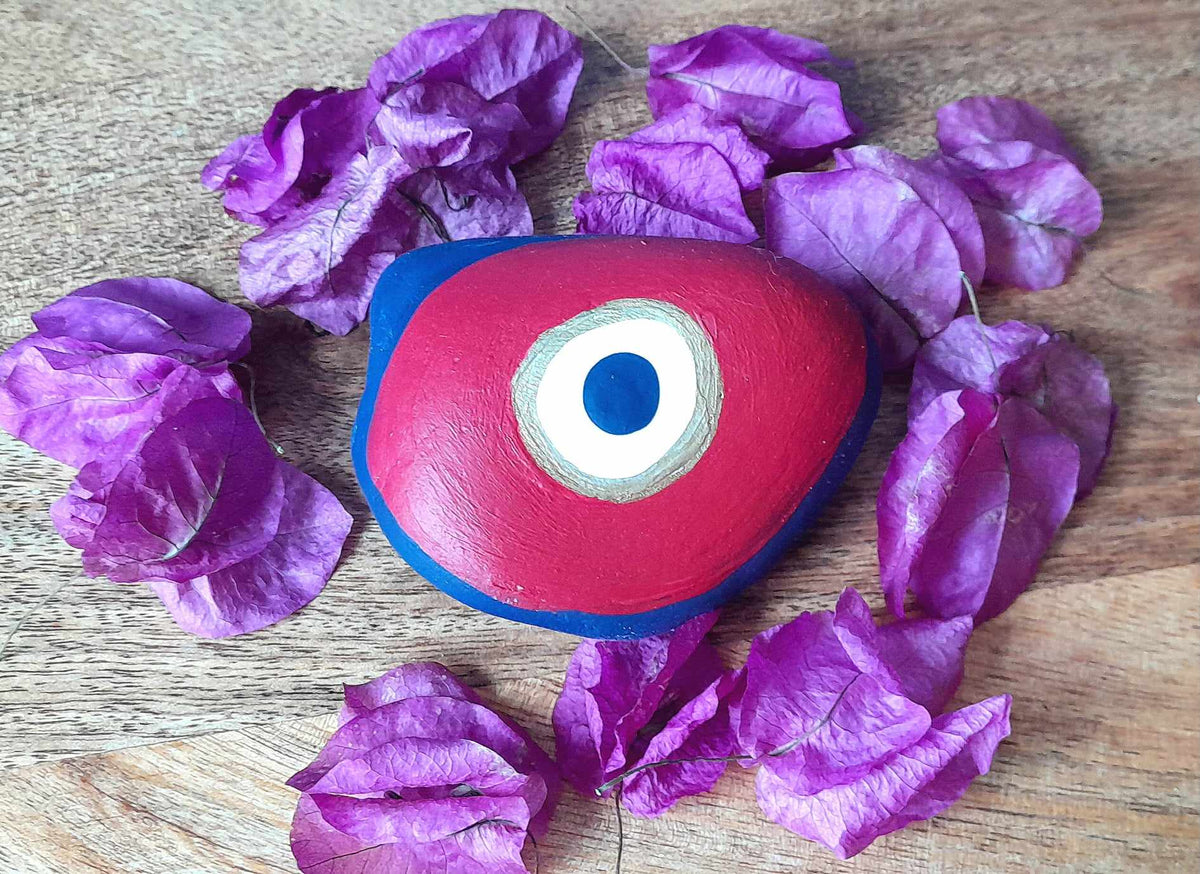 The red evil eye pebble magnetizing your gaze